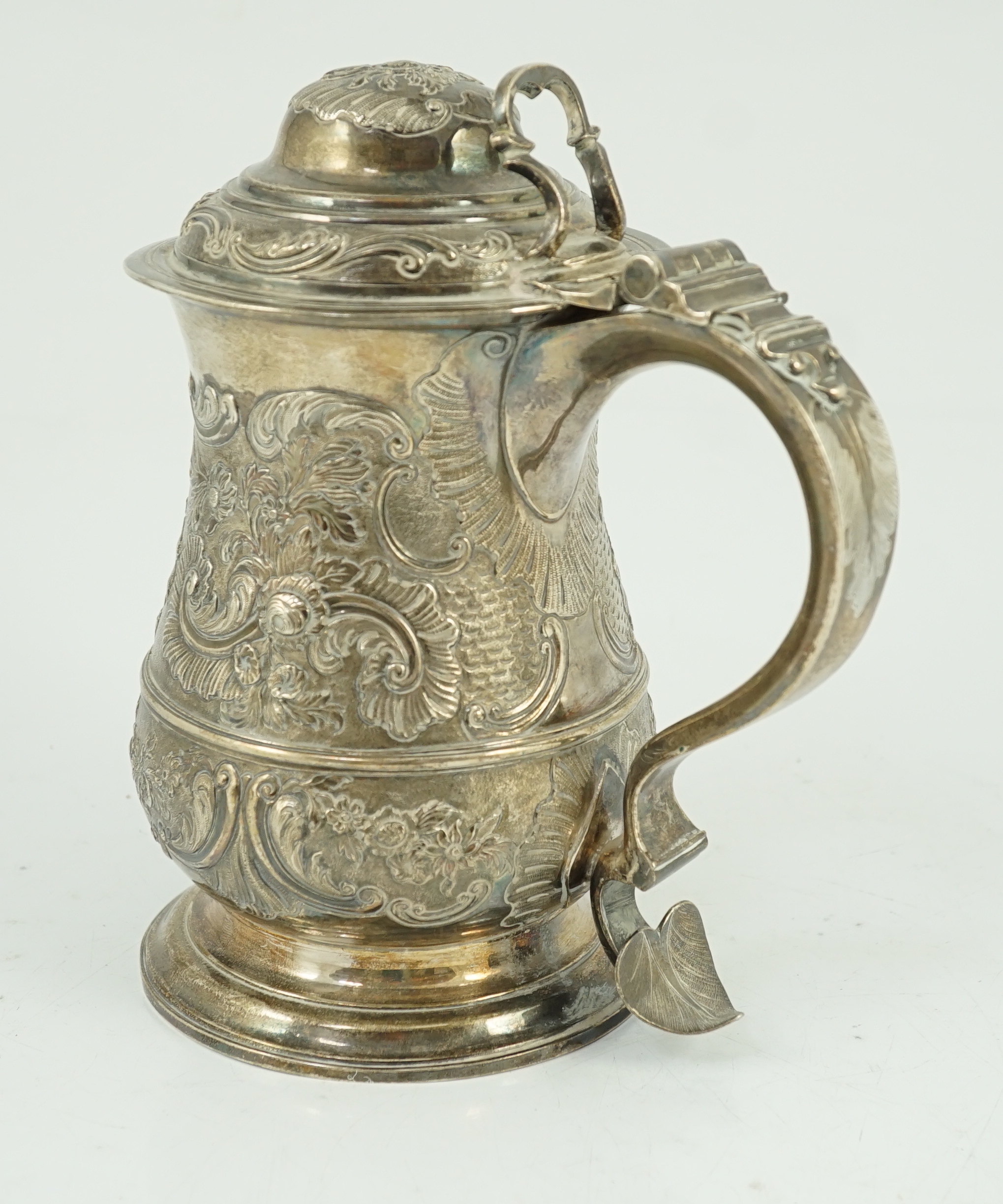 A George II silver baluster tankard, with later embossed decoration, by Robert Albin Cox